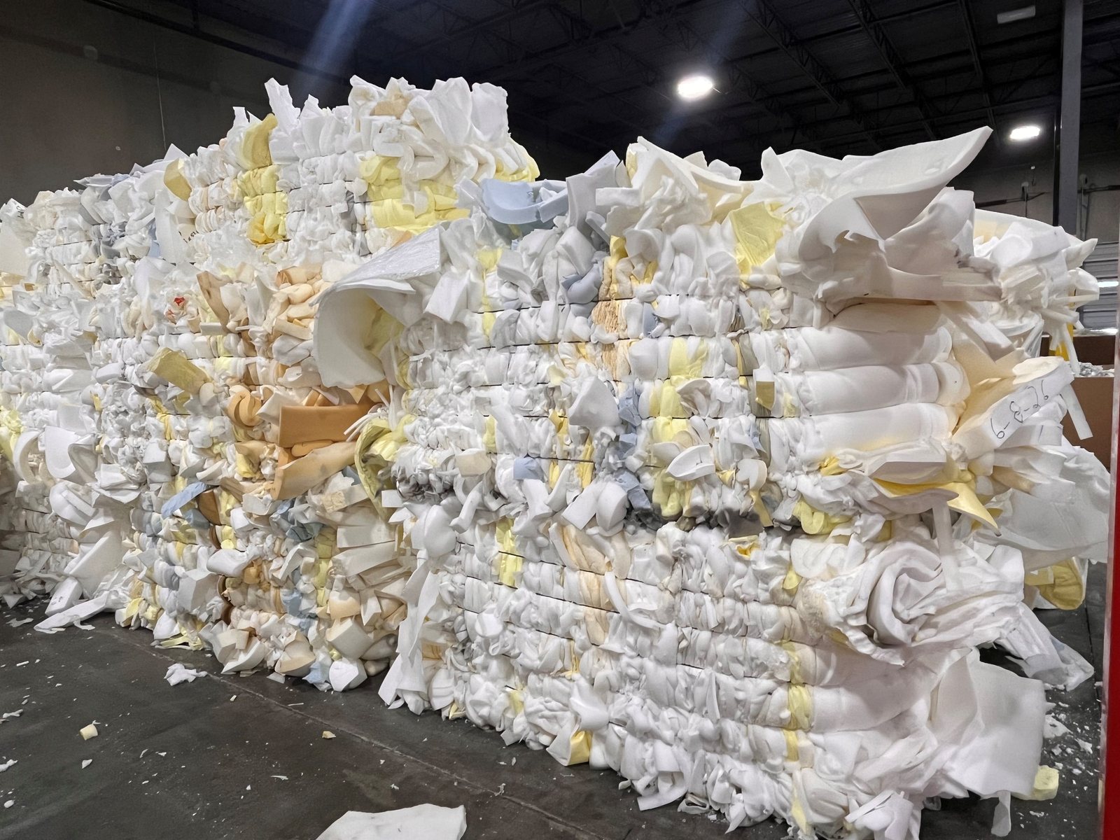 Bales of white and yellow prime polyurethane foam scrap, banded and stacked